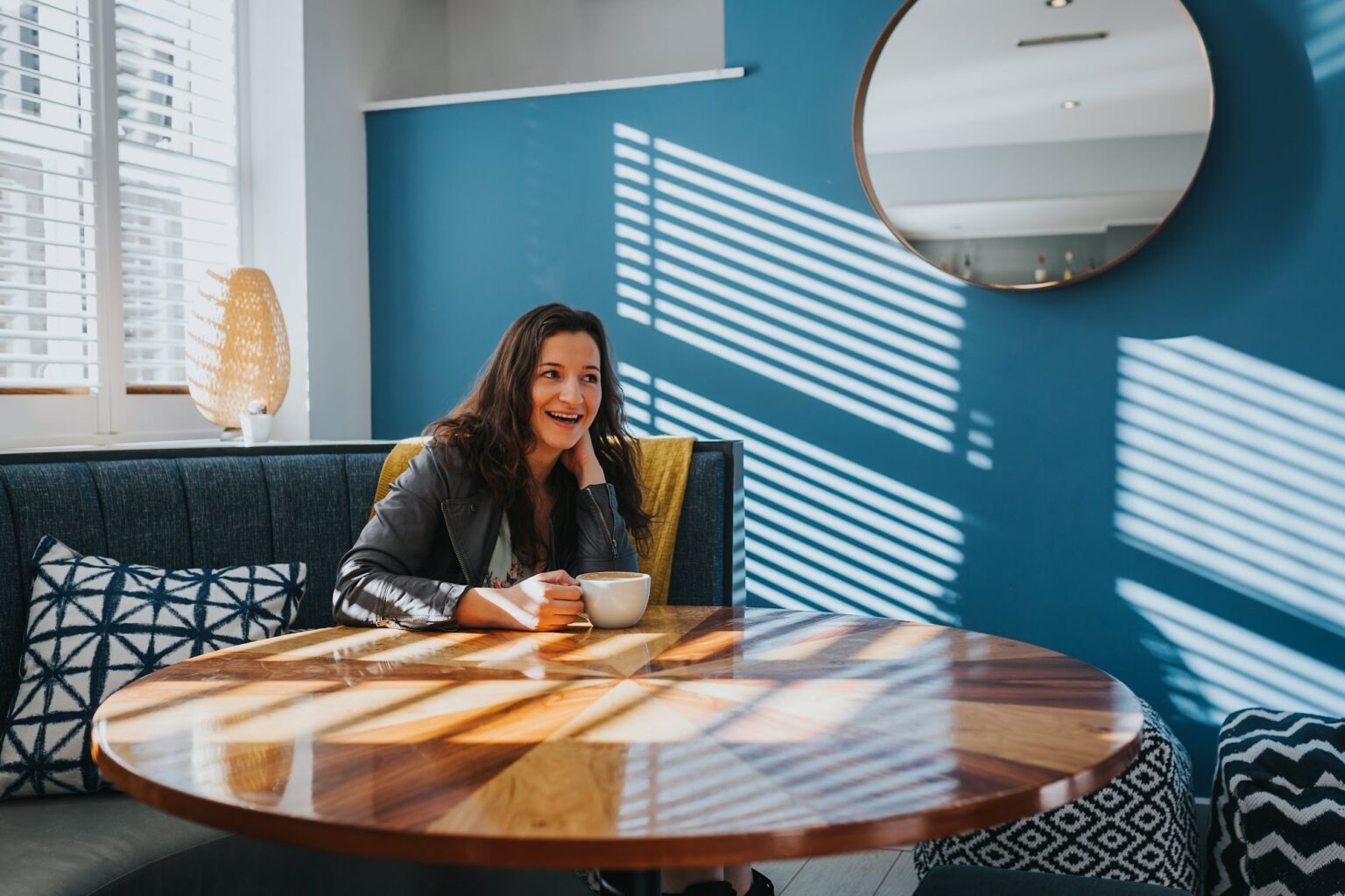 Rebecca Lockwood laughing at a table in a bright blue room